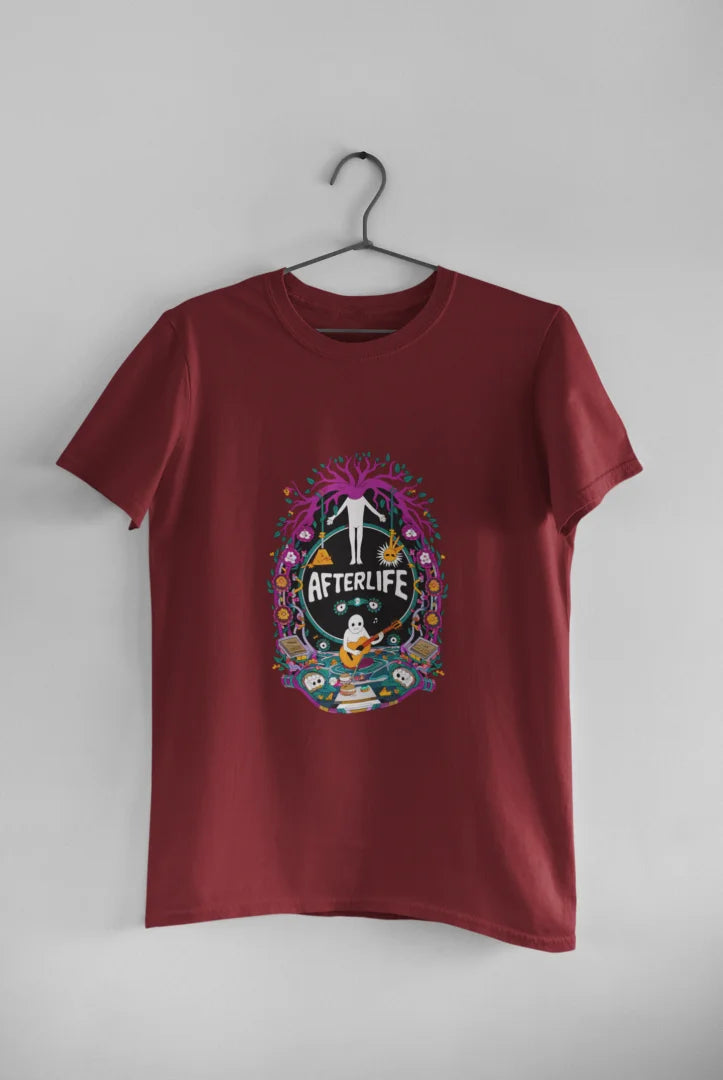 Maroon graphic print T-shirt hanging on a black hanger against a plain white background, featuring a psychedelic design reading Afterlife with a colorful, whimsical illustration of various shapes and colors, and a white silhouette of a person with arms outstretched in the center.