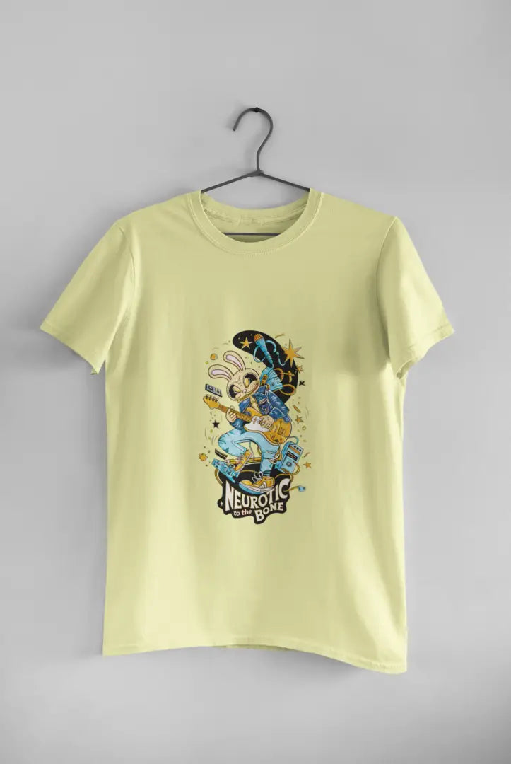 Butter Yellow band T-shirt hanging on a black hanger against a plain white background, featuring a colorful illustration of a cartoon character playing a guitar. The design has text Neurotic To The Bone in yellow letters, with stars and a crescent moon above the character in a playful design.