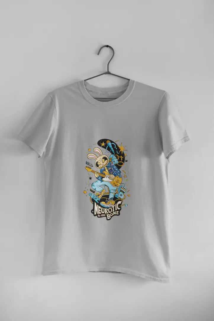 Grey band T-shirt hanging on a black hanger against a plain white background, featuring a colorful illustration of a cartoon character playing a guitar. The design has text Neurotic To The Bone in yellow letters, with stars and a crescent moon above the character in a playful design.