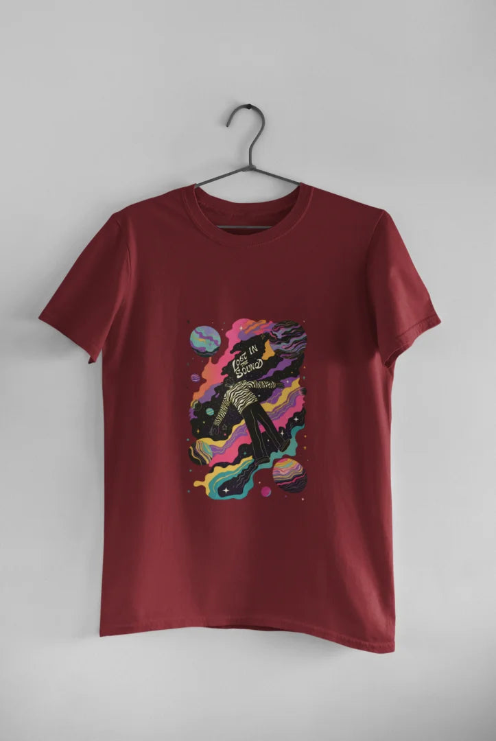 Maroon tee shirt with a cosmic design featuring a person in a black and white striped shirt floating in space.
