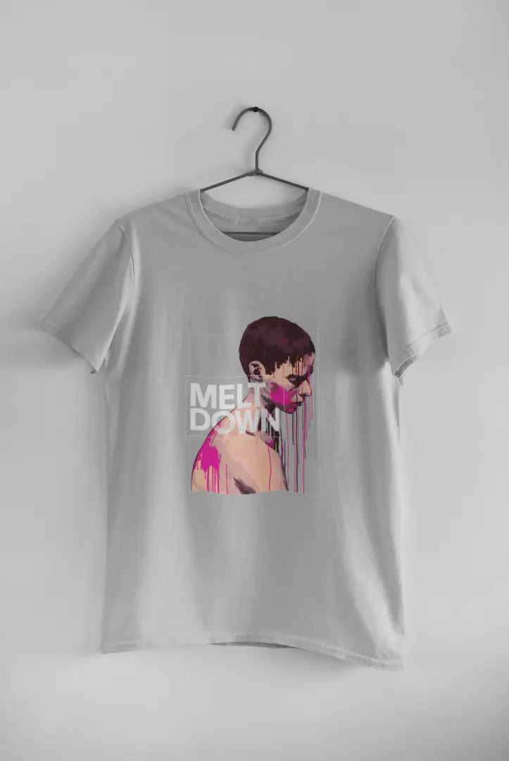 A grey t-shirt featuring a stylized portrait of a pensive young man with pink drips on his bare chest. Bold white text reads “MELT DOWN” within a dark gray rectangular frame. The design is graphic and dramatic.