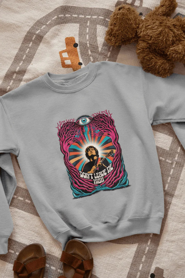A grey sweatshirt with a graphic print. The graphic features a young, light-skinned man, depicted from the mid-section up. He is playing a guitar. The man is positioned within an abstract design of swirling, colorful patterns and stylized, leaf-like forms in various shades of pink, purple, teal, orange, and yellow. A large, stylized eye is prominently featured in the design, situated above the man's head. The words "DON'T LEAVE ME HIGH" are printed below.