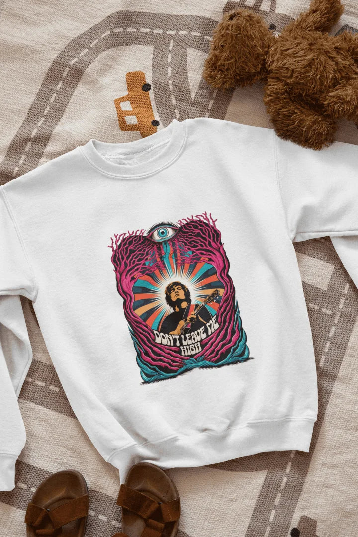A white sweatshirt with a graphic print. The graphic features a young, light-skinned man, depicted from the mid-section up. He is playing a guitar. The man is positioned within an abstract design of swirling, colorful patterns and stylized, leaf-like forms in various shades of pink, purple, teal, orange, and yellow. A large, stylized eye is prominently featured in the design, situated above the man's head. The words "DON'T LEAVE ME HIGH" are printed below.