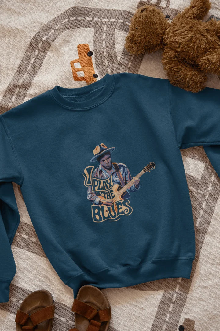 A navy blue sweatshirt with the design of a man playing guitar. There’s a text on the design saying I play the blues.