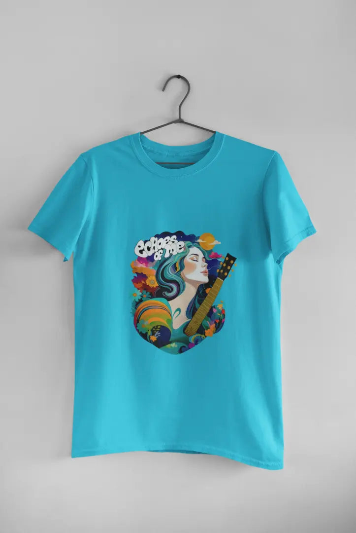 A blue T-shirt hanging against a grey background consisting of a psychedelic design of a girl holding a guitar. There’s a text saying echoes of me.