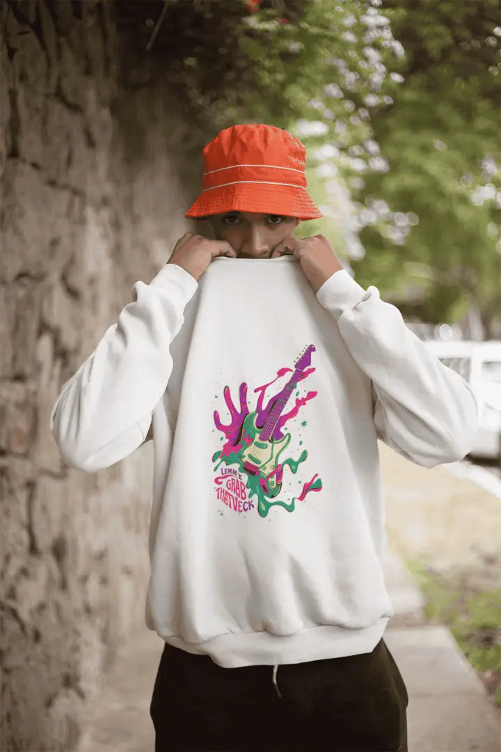 A man wearing a white sweatshirt with a front print. The sweatshirt design contains of a psychedelic design language with a guitar made up of paint, splashes and a hand at the back trying to grab it. There is a text saying let me grab that neck.