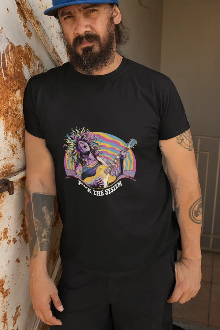 A man leaning against a wall wearing a black printed T-shirt. The T-shirt contains a design of a man playing guitar in feel. The design is a psychedelic design with the text F**K the system.