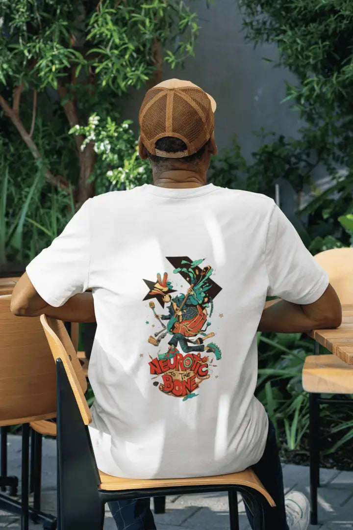 A man wearing a white back printed oversized T-shirt. The T-shirt design contains of a funky character with an instrument and a microphone in his hand. There’s a text saying “Neurotic to the bone”.