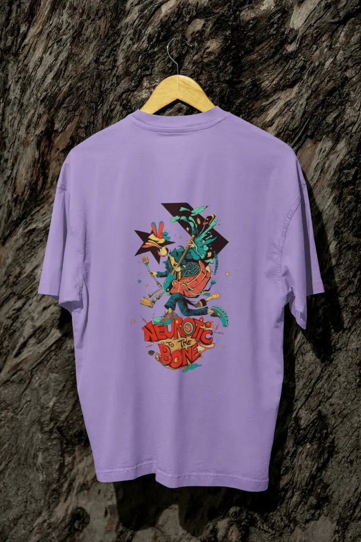 A lavender back printed oversized T-shirt with a hanging against a tree trunk. The T-shirt design contains of a funky character with an instrument and a microphone in his hand. There’s a text saying “Neurotic to the bone”.