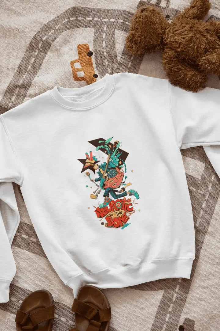 A white sweatshirt with a printed design lying on the floor. The design contains of a funky character with an instrument and a microphone in his hand. There’s a text saying “Neurotic to the bone”.