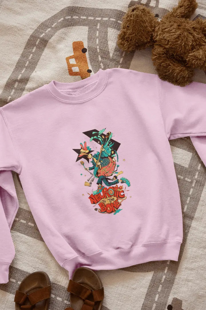 A pink sweatshirt with a printed design lying on the floor. The design contains of a funky character with an instrument and a microphone in his hand. There’s a text saying “Neurotic to the bone”.