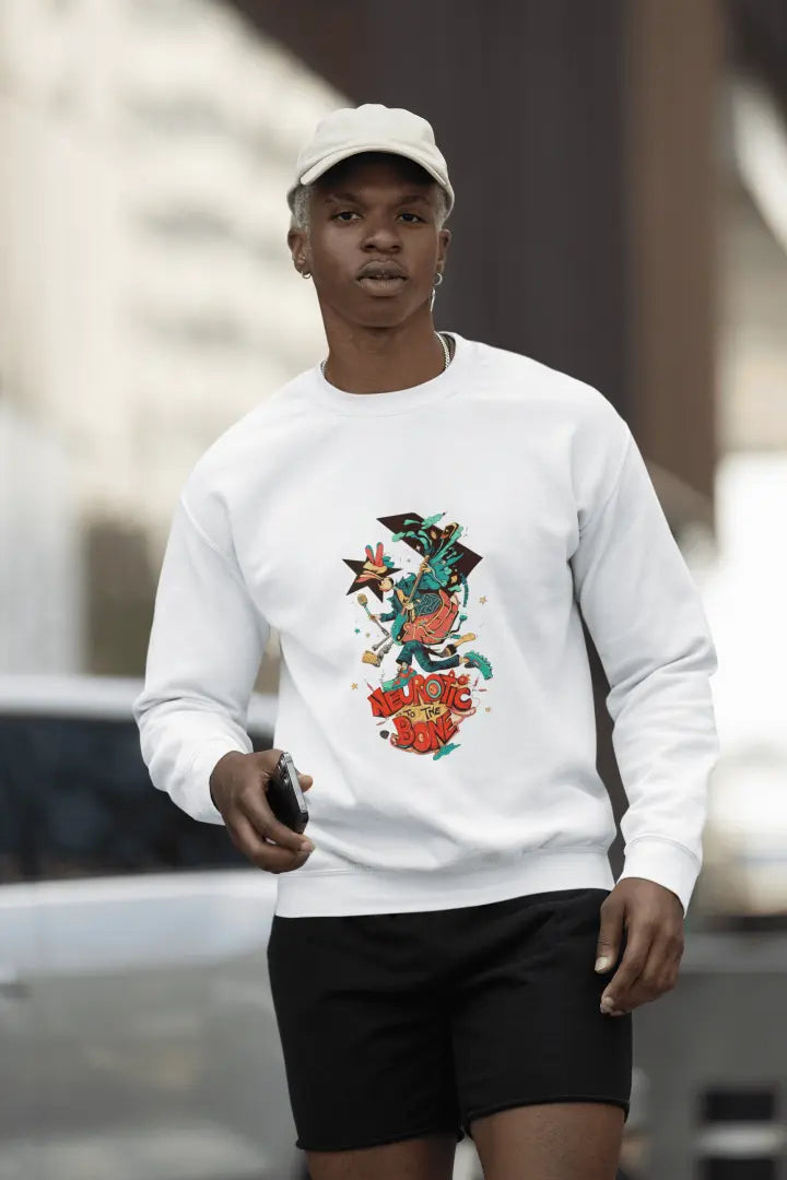 A man wearing a white sweatshirt with a printed design. The design contains of a funky character with an instrument and a microphone in his hand. There’s a text saying “Neurotic to the bone”.