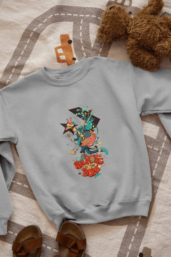 A melange grey sweatshirt with a printed design lying on the floor. The design contains of a funky character with an instrument and a microphone in his hand. There’s a text saying “Neurotic to the bone”.