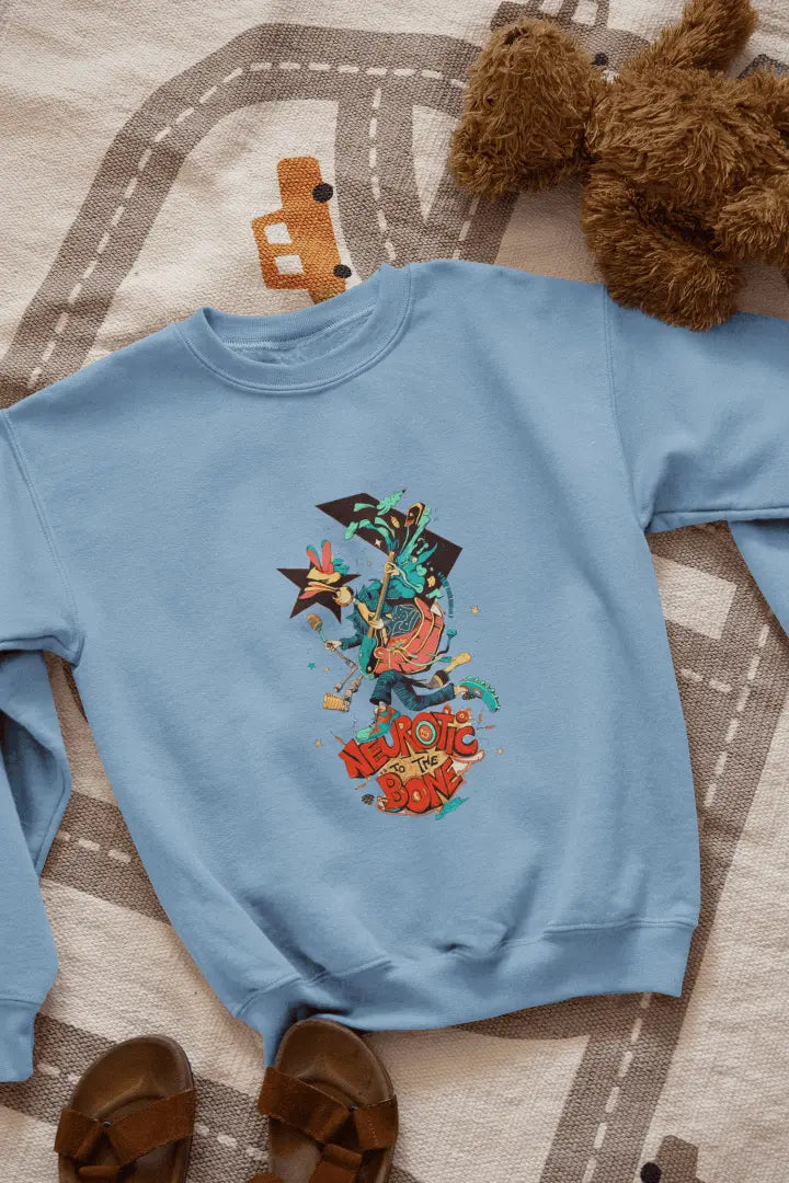 A baby blue sweatshirt with a printed design lying on the floor. The design contains of a funky character with an instrument and a microphone in his hand. There’s a text saying “Neurotic to the bone”.