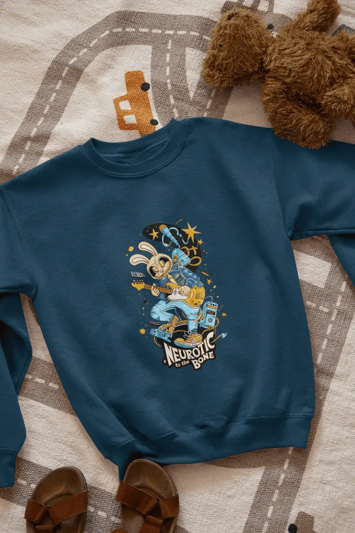 A navy blue sweatshirt with a printed design lying on the floor. The design contains of a funky character playing a guitar. There’s a text saying “Neurotic to the bone” at the bottom of the design.