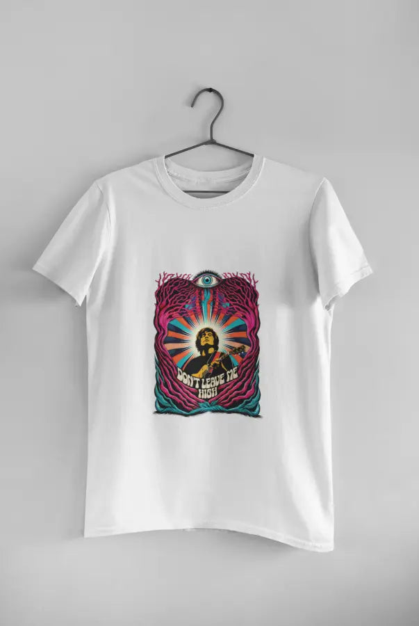 A white t-shirt with a psychedelic design printed on the front hanging against a light grey wall. The design contains a man playing guitar with his eyes closed. The overall design is psychedelic with an eye at the top and a text saying Don't leave me high at the bottom of the design.