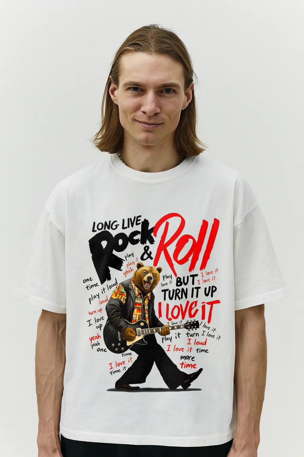 Person wearing a white t-shirt with a graphic design of a bear playing guitar and text about rock and roll.