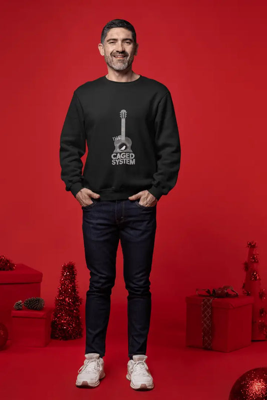 A man wearing a black sweatshirt with a minimal design printed on the front. The design consists of an acoustic guitar inside which a small bird is sitting. There's a text saying The Caged System at the bottom of the design.