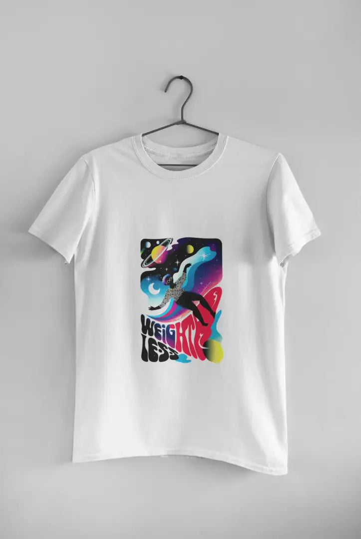 A white t-shirt with a design printed on the front hanging against a light grey wall. The design contains a woman who is floating in space with planets and stars around her. There's a text saying Weightless at the bottom of the design.