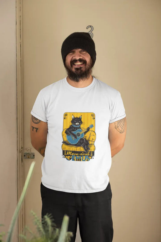 Man wearing a white cat T-shirt with a graphic design of a black cat playing a blue guitar on a yellow background. He has a beard, black beanie, tattoos on his arms, and is smiling at the camera, standing in front of a beige wall with a plant in the front.