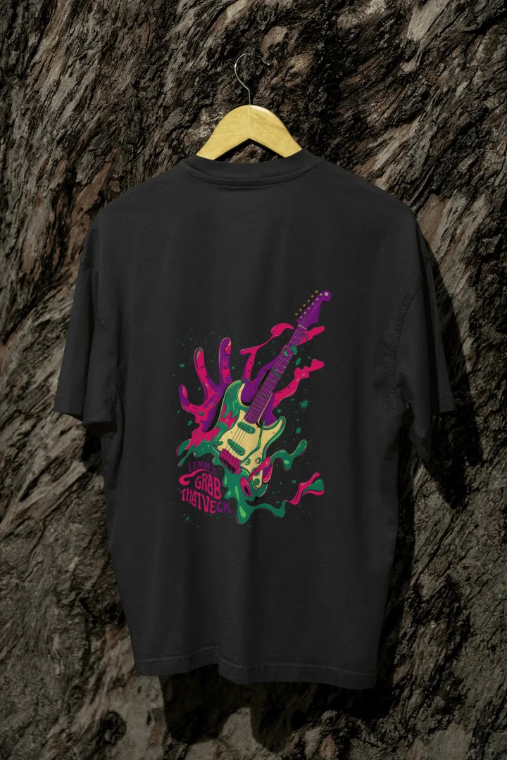 Black oversized designer T-shirt with a back print of a psychedelic guitar and a hand trying to grab it from the back. The design is vibrant and contains paint splashes and the text Let new grab that neck. 