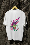 White oversized designer T-shirt with a back print of a psychedelic guitar and a hand trying to grab it from the back. The design is vibrant and contains paint splashes and the text Let new grab that neck. 