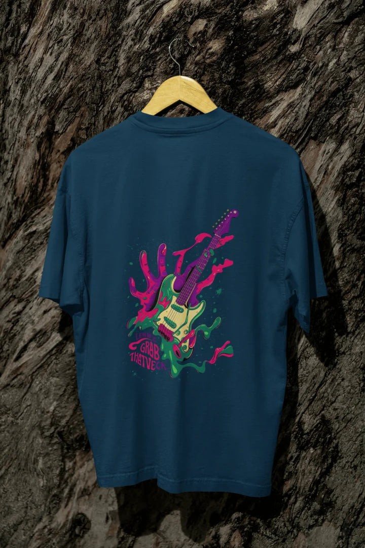Navy blue oversized designer T-shirt with a back print of a psychedelic guitar and a hand trying to grab it from the back. The design is vibrant and contains paint splashes and the text Let new grab that neck. 