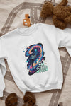 White sweatshirt lying on the floor. The sweatshirt contains a design of a man floating in space. There is a text saying lost in the sound.