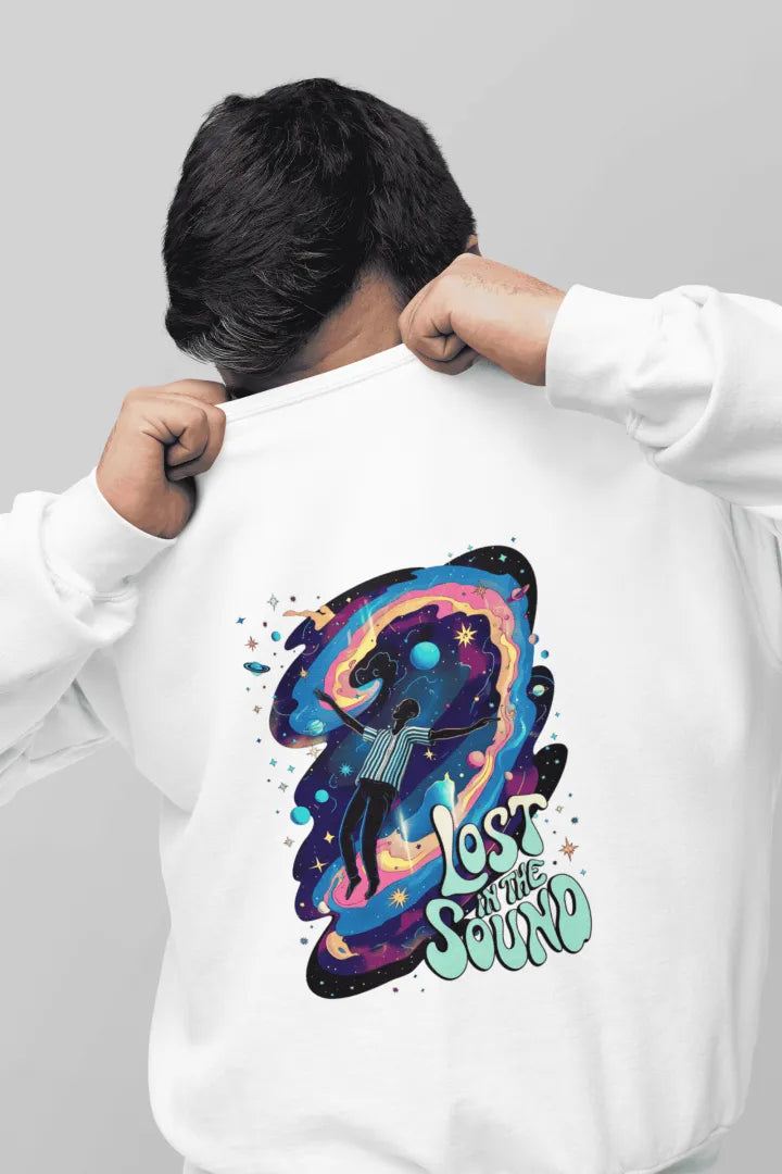A man wearing a white sweatshirt, he has covered his face by pulling up the sweatshirt. The sweatshirt contains a design of a man floating in space. There is a tech saying lost in the sound.