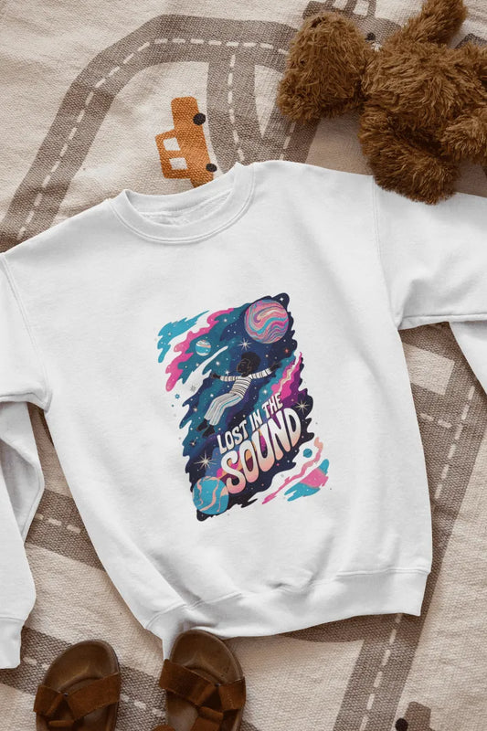 A printed white sweatshirt lying on the floor with the design of a man floating in space. There’s a text saying Lost in the Sound.