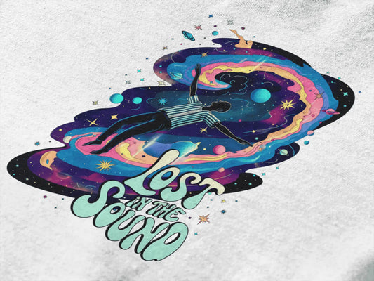 A close up of a design printed on a t-shirt. The design contains a man floating in space with planets and stars around him. There's a text saying Lost in The Sound on the bottom right of the design.