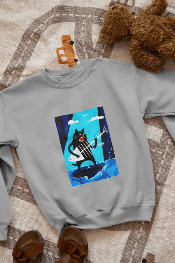 A grey sweatshirt with a design printed on the front lying on the floor. The design contains a cat standing on an iceberg holding a fish bone which appears to be like a guitar. There's a text saying Solo Time on the right side.