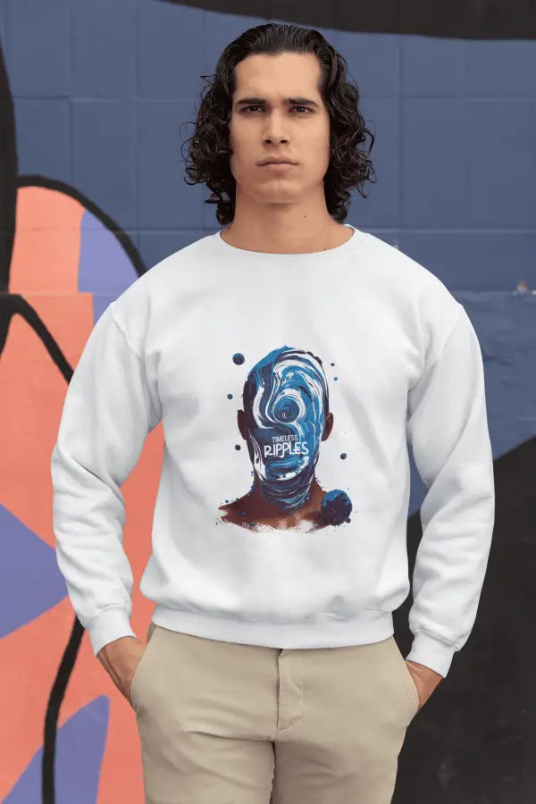 A man wearing a white sweatshirt with a design printed on the front. The design contains a character whose face is made out of ripples of wave. There's a text saying Timeless Ripples at the center of the design.